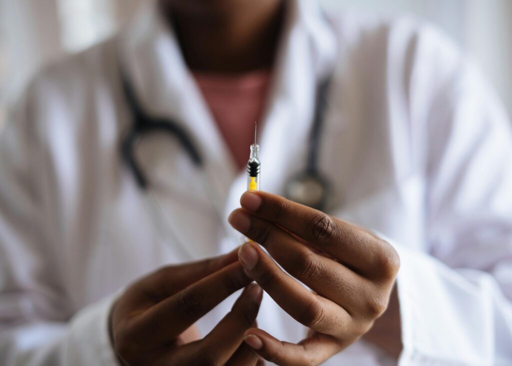 pexels-photo-3825529-3825529 Close-up of a healthcare professional holding a syringe, symbolizing medical care and vaccination.